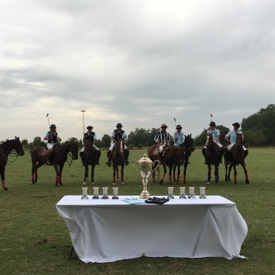 Polo players and trophies in polo field in Argentina