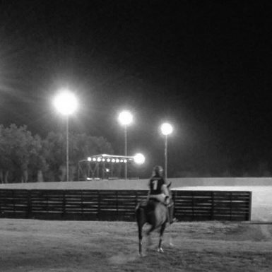 polo player heading illuminated arena polo field