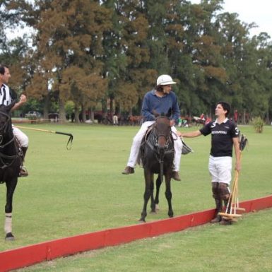 polo players chatting in polo field in between chukkas