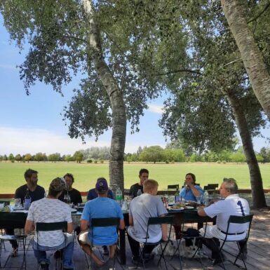 polo players having lunch next to polo field